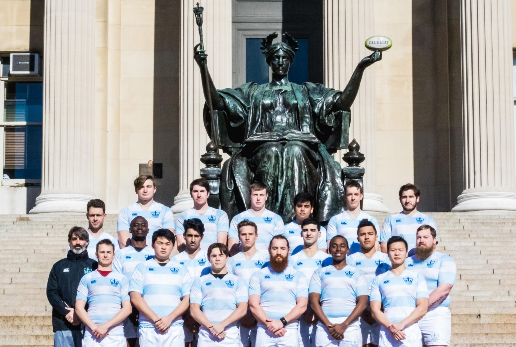 Columbia's Men's Rugby Team poses in front of Alma Mater.